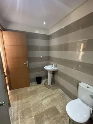 a bathroom with a toilet and a sink at Rabat en face de océan in Rabat