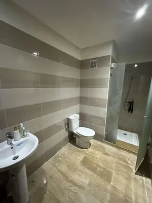 a bathroom with a toilet and a sink and a shower at Rabat en face de océan in Rabat