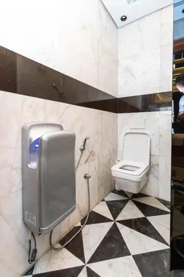 a bathroom with a toilet and a toilet paper dispenser at Anfa Studio Sea View in Casablanca