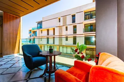 a balcony with a table and chairs and a building at Anfa Studio Sea View in Casablanca