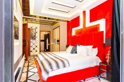 a red bedroom with a large bed with a red headboard at Anfa Studio Sea View in Casablanca