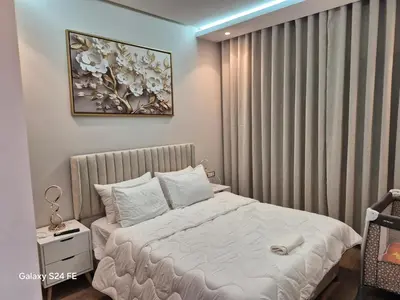 a bedroom with a bed and a painting on the wall at Aeroperla Prestige Casablanca Airport in Nouaseur