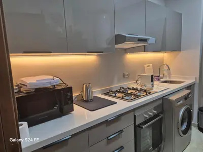a kitchen with a stove top oven next to a microwave at Aeroperla Prestige Casablanca Airport in Nouaseur