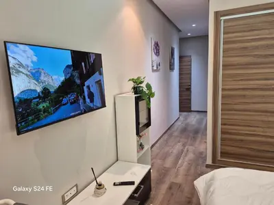 a bedroom with a flat screen tv on the wall at Aeroperla Prestige Casablanca Airport in Nouaseur
