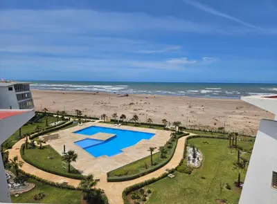 a view of the beach from the balcony of a condo at Ocean blue by rachid in Dar Oulad Hajj Kassem