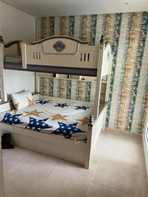a bedroom with a bunk bed with blue and white sheets at Ocean blue by rachid in Dar Oulad Hajj Kassem