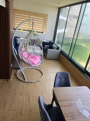 a swing in a room with a table and chairs at Ocean blue by rachid in Dar Oulad Hajj Kassem