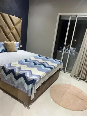 a bedroom with a bed and a balcony with a view at Ocean blue by rachid in Dar Oulad Hajj Kassem