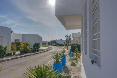 an empty street next to a building with plants at Luxury Oceanfront 3BR Villa in Rabat, Plage Val d Or - Private Beach access & Spa in Temara