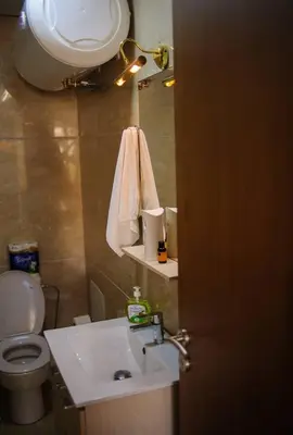 a bathroom with a sink and a toilet and a mirror at Luxury Oceanfront 3BR Villa in Rabat, Plage Val d Or - Private Beach access & Spa in Temara