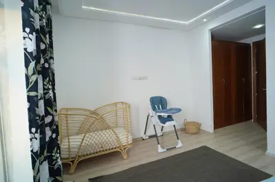 a living room with a chair and a chair at Luxury Oceanfront 3BR Villa in Rabat, Plage Val d Or - Private Beach access & Spa in Temara