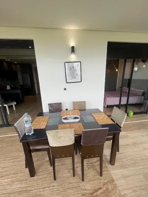 a dining room table and chairs in a room at Relaxing Apartment Oceanic Sidi Rahal in Sidi Rahal