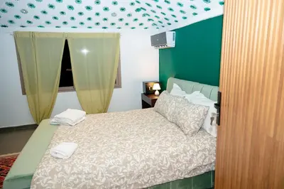 a bedroom with a bed with two towels on it at Maison à Skhirat Jacuzzi, jardin & proche plage in Skhirat