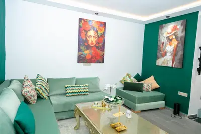 a living room with a couch and a table at Maison à Skhirat Jacuzzi, jardin & proche plage in Skhirat