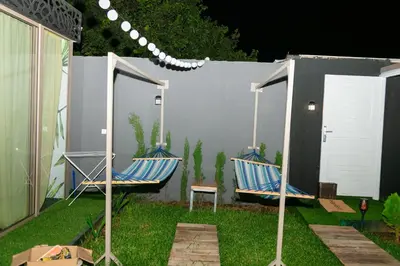 two chairs and a table in a yard at Maison à Skhirat Jacuzzi, jardin & proche plage in Skhirat