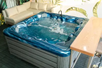 a blue tub sitting on a patio with a couch at Maison à Skhirat Jacuzzi, jardin & proche plage in Skhirat