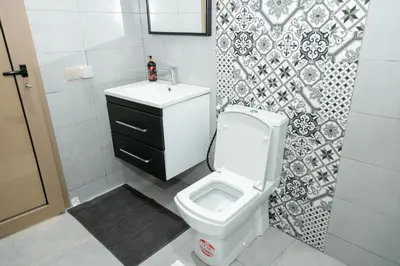a bathroom with a white toilet and a sink at Maison à Skhirat Jacuzzi, jardin & proche plage in Skhirat