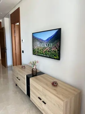 a living room with a tv on a wall at Tour 33 CFC Studio moderne & raffiné en plein cœur de Casa in Casablanca