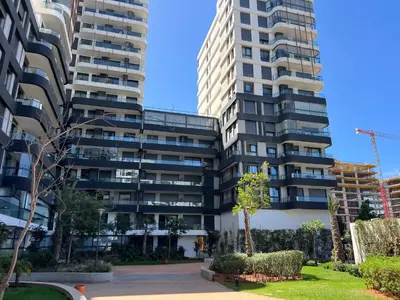 two tall buildings in a city with a park at Tour 33 CFC Studio moderne & raffiné en plein cœur de Casa in Casablanca