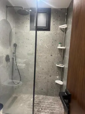 a shower with a glass door in a bathroom at Superbe T2 moderne au cœur du Maarif Confort & Style in Casablanca