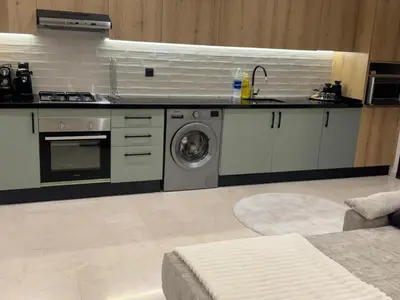 a kitchen with a sink and a washing machine at Superbe T2 moderne au cœur du Maarif Confort & Style in Casablanca