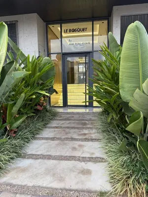 a front door of a building with plants in front at Superbe T2 moderne au cœur du Maarif Confort & Style in Casablanca