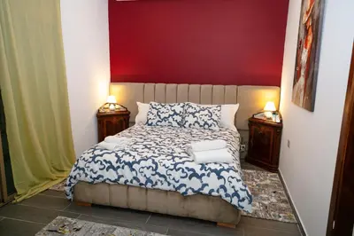 a bedroom with a bed and two night stands at Maison à Skhirat avec Jacuzzi et Jardin privé in Skhirat