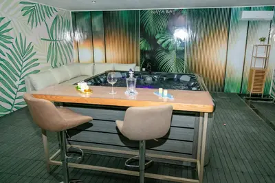 a table with two chairs and a bath tub at Maison à Skhirat avec Jacuzzi et Jardin privé in Skhirat