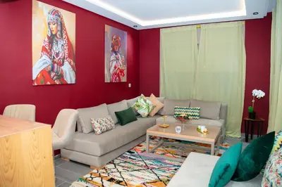 a living room with a couch and a table at Maison à Skhirat avec Jacuzzi et Jardin privé in Skhirat