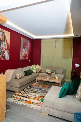 a living room with a couch and a table at Maison à Skhirat avec Jacuzzi et Jardin privé in Skhirat