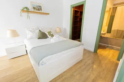 a bedroom with a white bed and a bathroom at Casa JOY in Casablanca