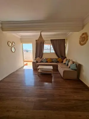 a large living room with a couch and a table at Petit Nid Casablanca in Casablanca
