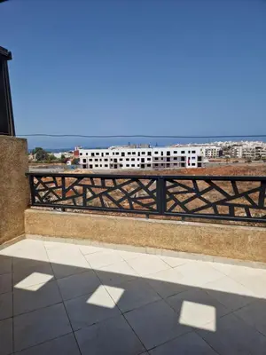 a balcony with a fence and a view of a city at Sable d'or in O Ben Slimane