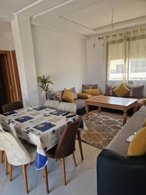 a living room with a table and a couch at Sable d'or in O Ben Slimane