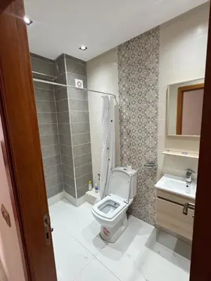 a bathroom with a toilet and a sink at Résidence oasis beach mansouriah in Mohammedia