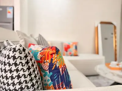 a living room with pillows on a couch at Bright Cosy Apartment By Mohamed V Stadium in Casablanca