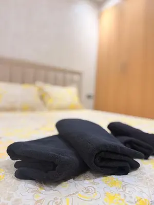 a pile of black towels sitting on a bed at Bright Cosy Apartment By Mohamed V Stadium in Casablanca