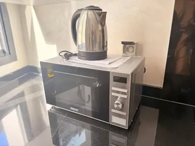 a blender sitting on top of a microwave at Bright Cosy Apartment By Mohamed V Stadium in Casablanca