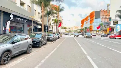 a street with cars parked on the side of the road at Bright Cosy Apartment By Mohamed V Stadium in Casablanca