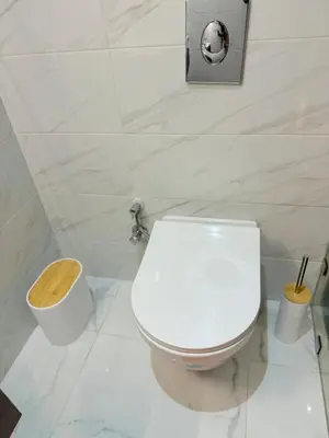 a white bathroom with a toilet and a trash can at Cosy Modern Retreat in Casablanca in Casablanca