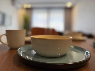 a cup and a plate on a wooden table at Cosy Modern Retreat in Casablanca in Casablanca