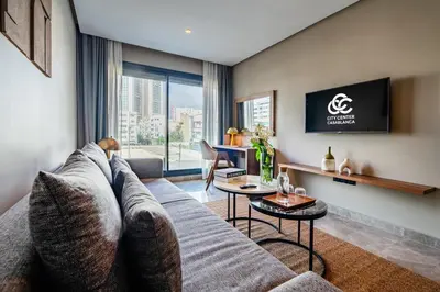 a living room with a couch and a table at Casablanca City Center Maarif in Casablanca
