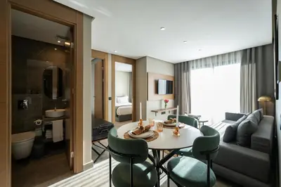 a living room with a table and chairs and a couch at Casablanca City Center Maarif in Casablanca