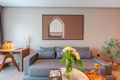 a living room with a couch and a table at Casablanca City Center Maarif in Casablanca