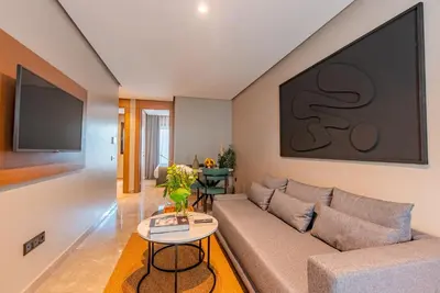 a living room with a couch and a tv at Casablanca City Center Maarif in Casablanca