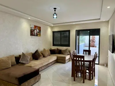 a living room with a couch and a table at Luxury Casablanca Studio - Close to Tram in Casablanca