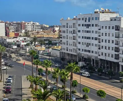 a city with buildings and palm trees and a street at Luxury Casablanca Studio - Close to Tram in Casablanca
