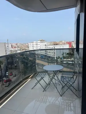 a balcony with a table and a view of a city at Casablanca luxury Studio in Casablanca