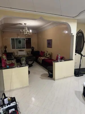 a living room with a couch and a table at Maison kossay in Casablanca