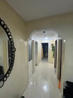 a hallway with a mirror on the wall and a hallway sidx sidx sidx at Maison kossay in Casablanca
